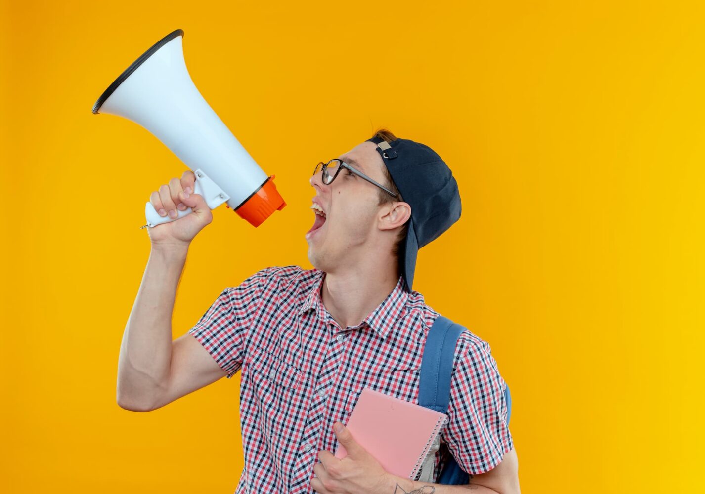 looking-side-young-student-boy-wearing-back-bag-glasses-cap-speaks-loudspeaker-holding-notebook (1) looking-side-young-student-boy-wearing-back-bag-glasses-cap-speaks-loudspeaker-holding-notebook (1)